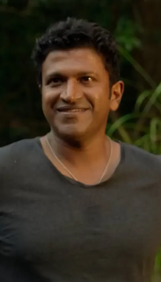 a man in a gray shirt is smiling