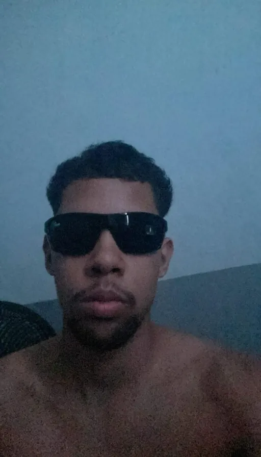 a shirtless man wearing sunglasses and no shirt