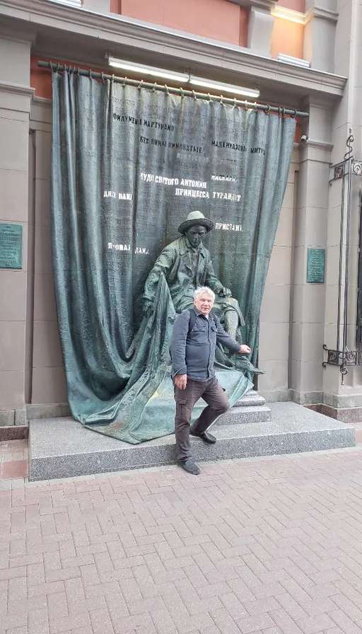 a man standing in front of a statue