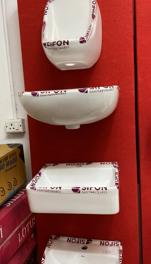 a red wall with three white bowls on it