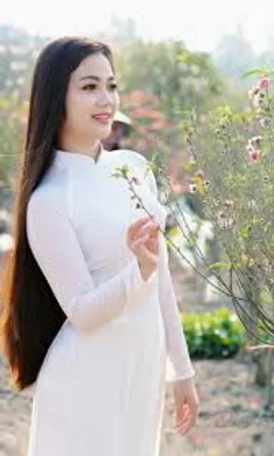 a woman in a white dress holding a flower