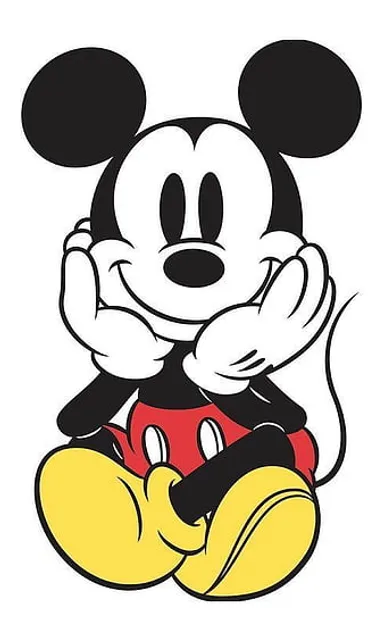 a mickey mouse sitting on top of a white surface