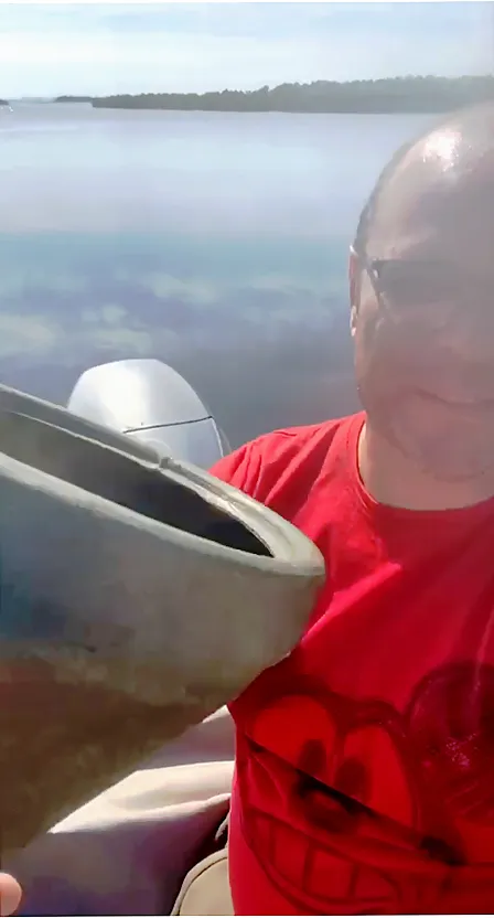 a man in a red shirt on a boat