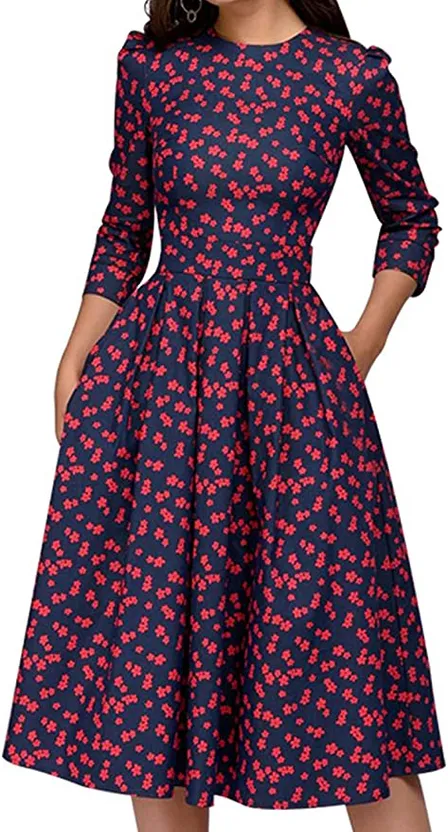 a woman wearing a dress with red flowers on it