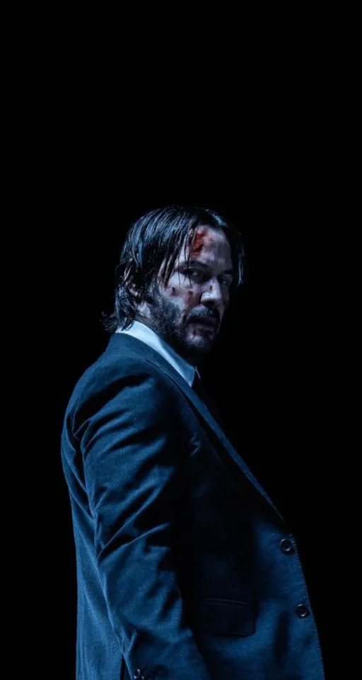 a man in a suit and tie standing in the dark