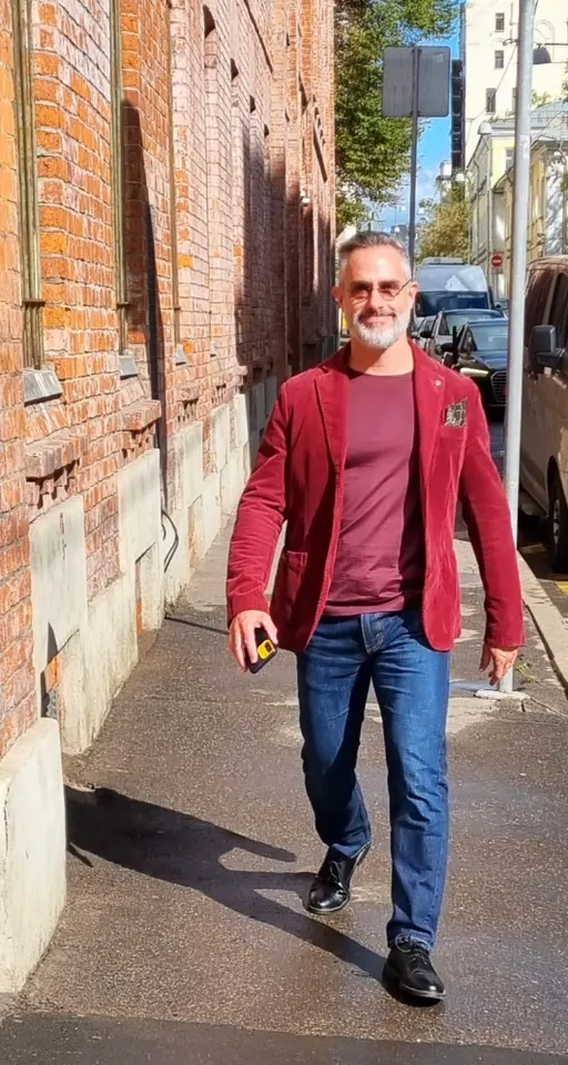 a man walking down a street next to a brick building