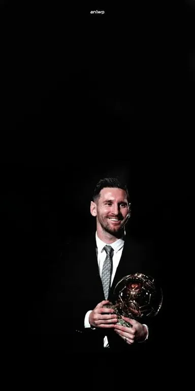 a man in a suit and tie holding a trophy