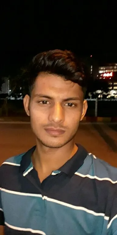 a man standing in a parking lot at night