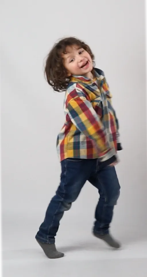 a little boy is jumping on a white background