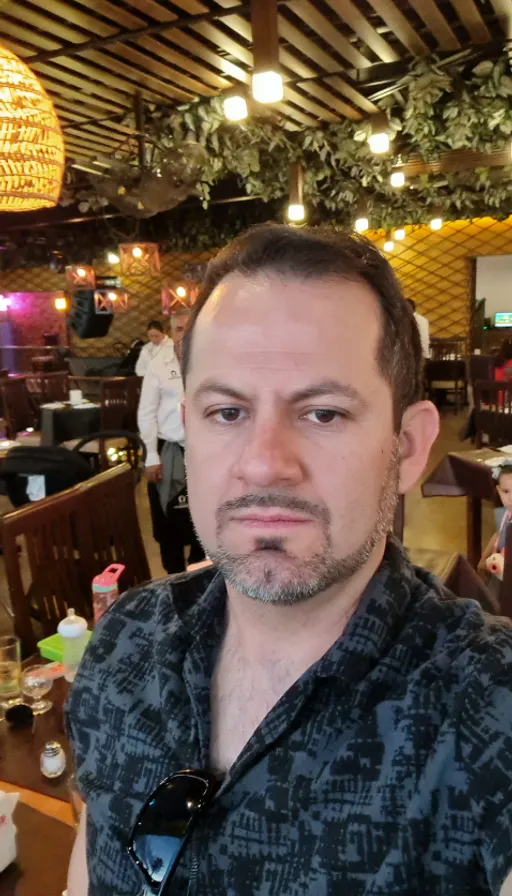 a man sitting at a table in a restaurant