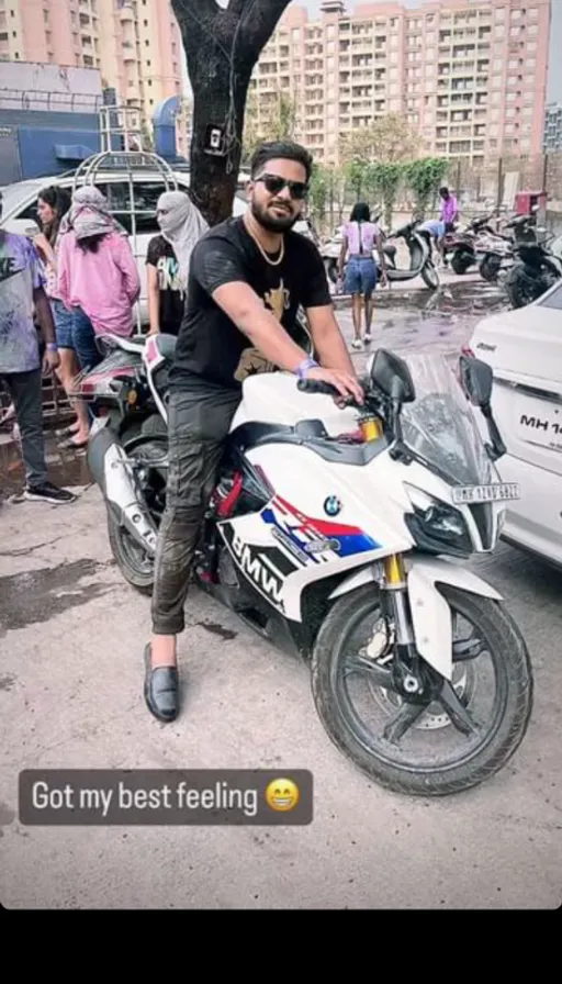 a man sitting on a motorcycle in a parking lot