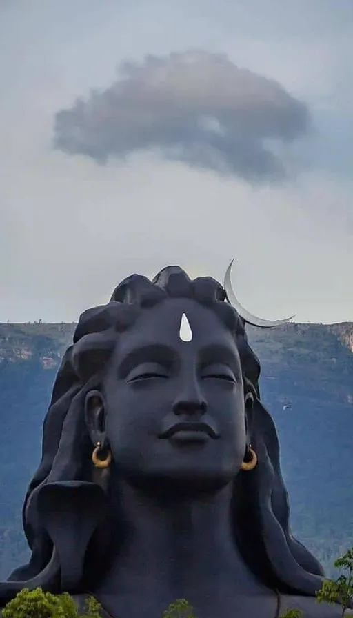 a statue of a woman with a crescent in her hair