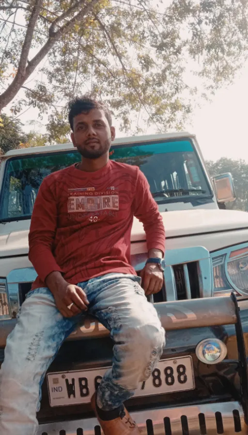 a man sitting on the hood of a car