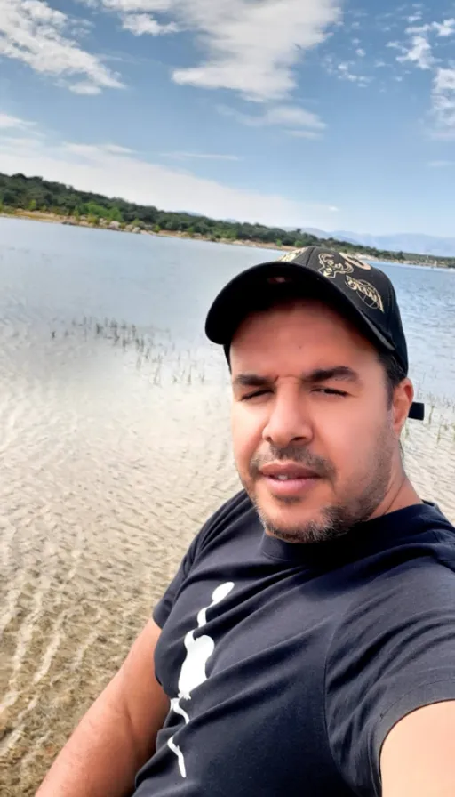 a man taking a selfie on the beach