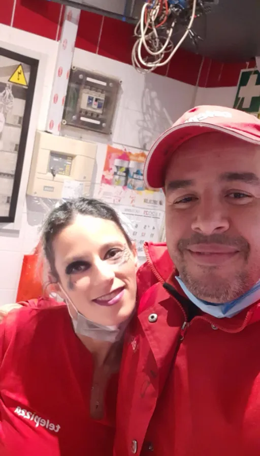 a man in a red jacket and a woman in a red hat