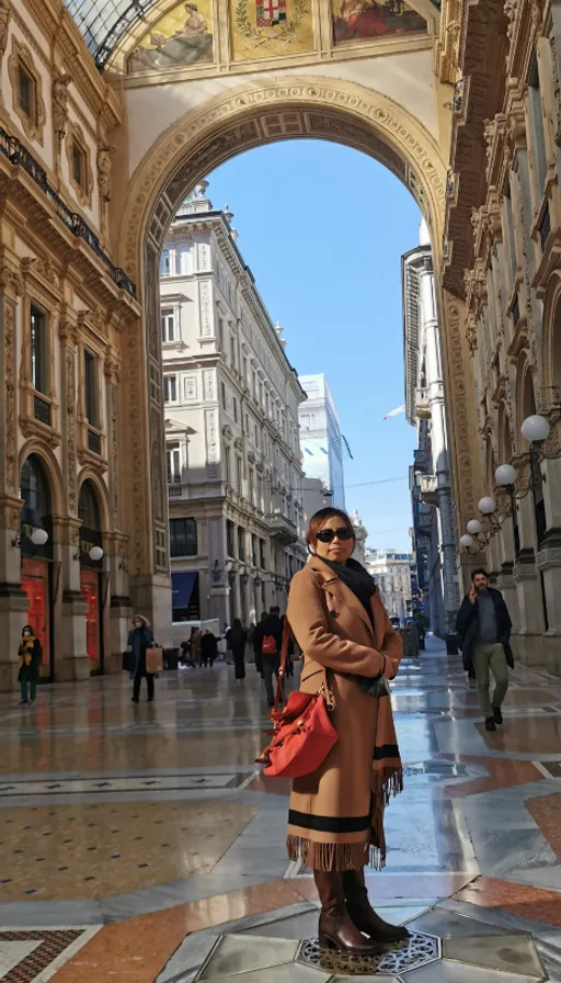 a woman is standing in the middle of a street