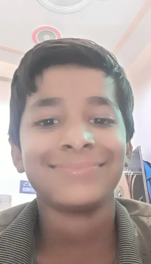 a young boy is smiling at the camera