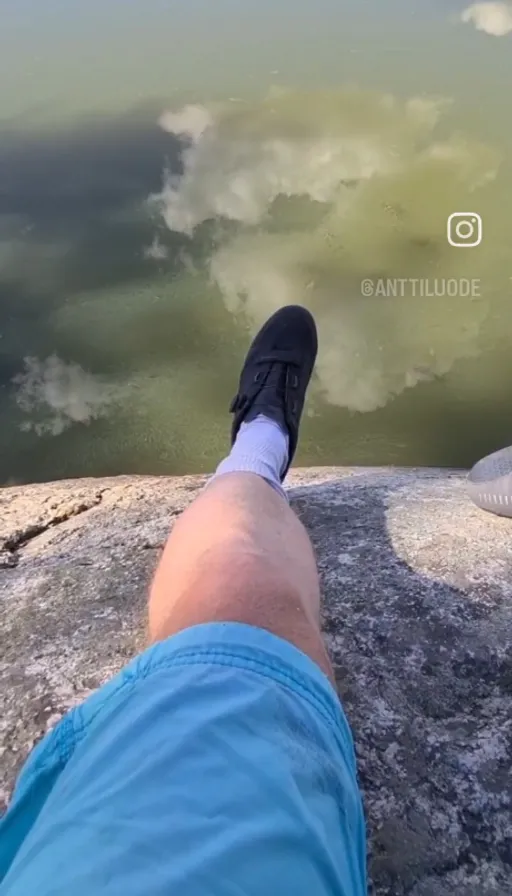 a person dangling their feet over a precipice, with their feet up on the edge of a cliff. have them dangling over a precipice