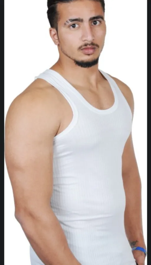 a man in a white tank top posing for a photo