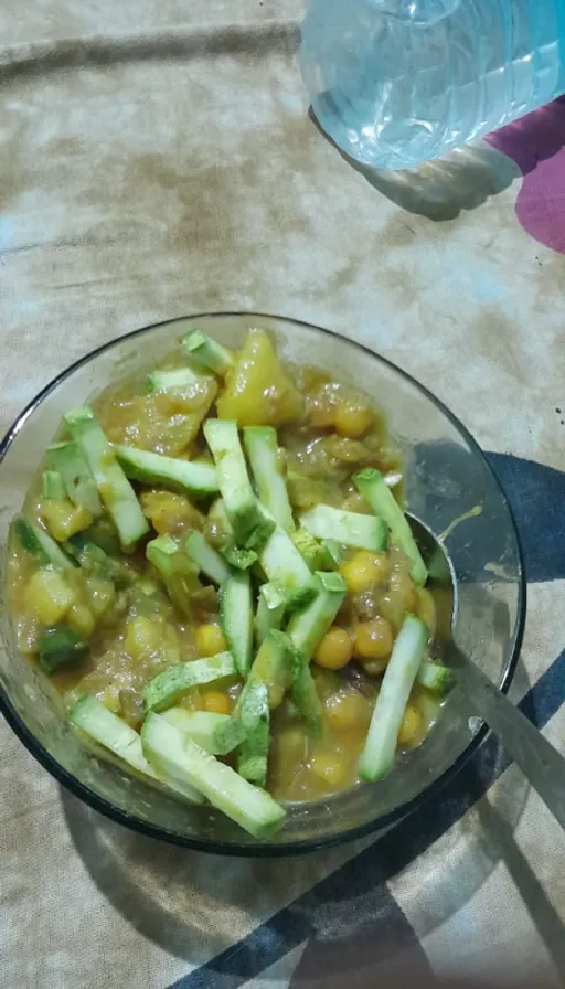 a glass bowl filled with vegetables on top of a table