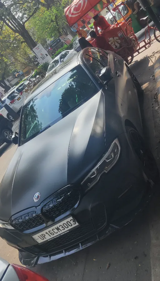 a black car parked on the side of the road