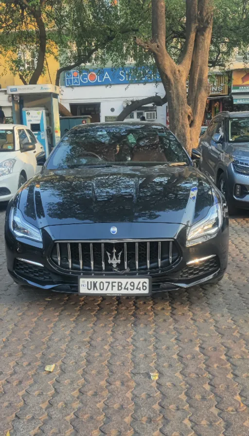 a black masera parked on the side of the road