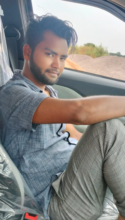 a man sitting in the passenger seat of a car