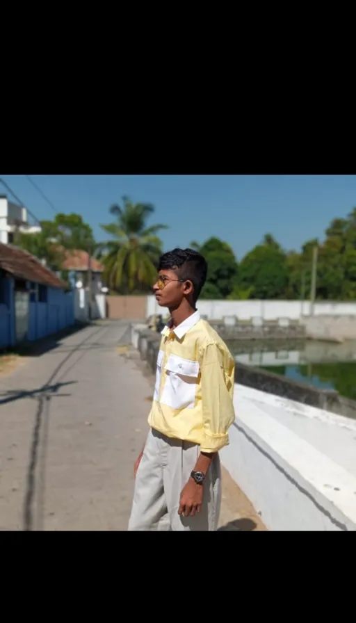 a young man standing on the side of the road, in Kenya, after the Kgf. 2 earthquake. Kgf. 2