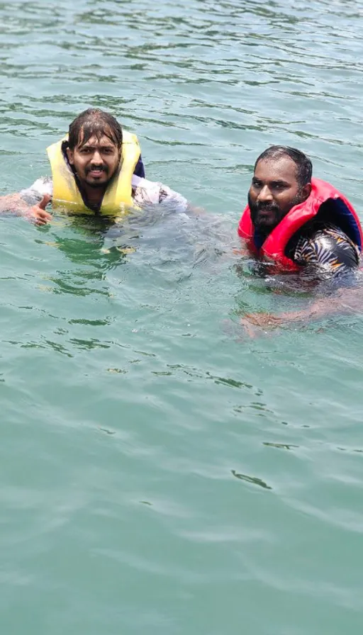 two people in the water wearing life jackets