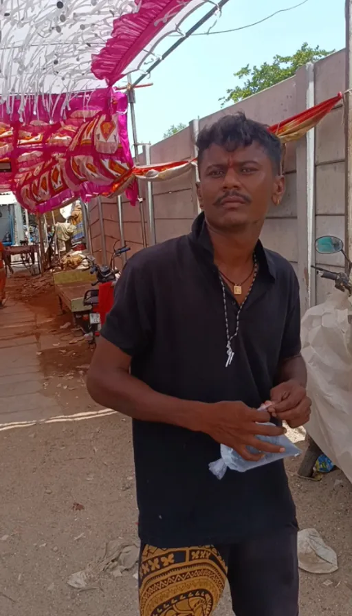 a man standing under an umbrella holding a piece of paper