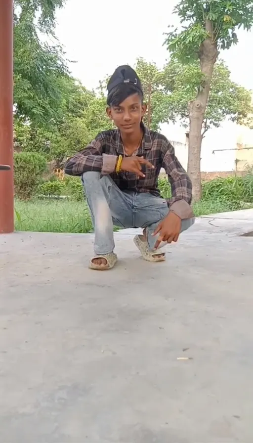 a young man kneeling down on a skateboard