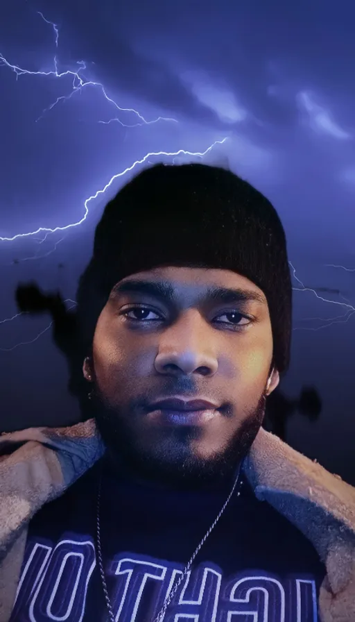 a man in a black shirt and a lightning storm in the background