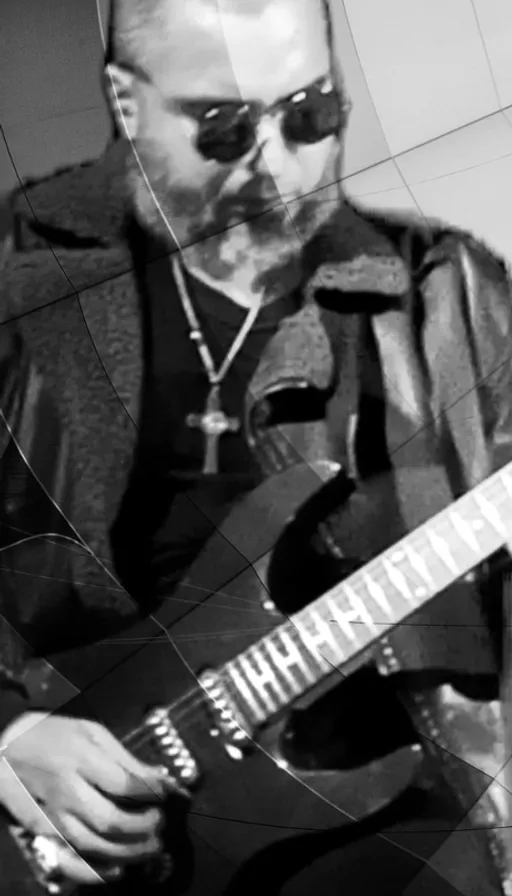 a man playing an acoustic guitar in a black and white photo