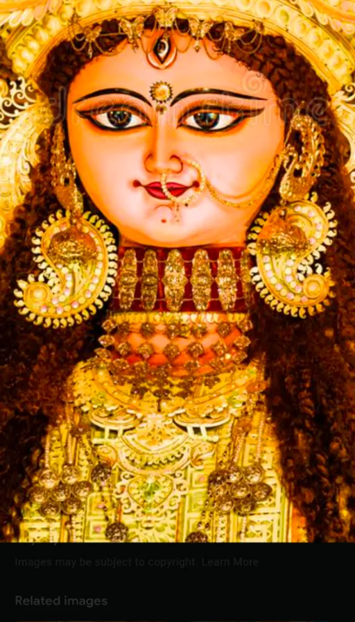 a picture of a hindu goddess with gold ornaments