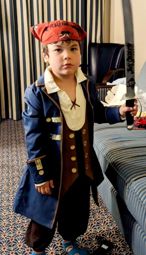 a little boy dressed in a pirate costume