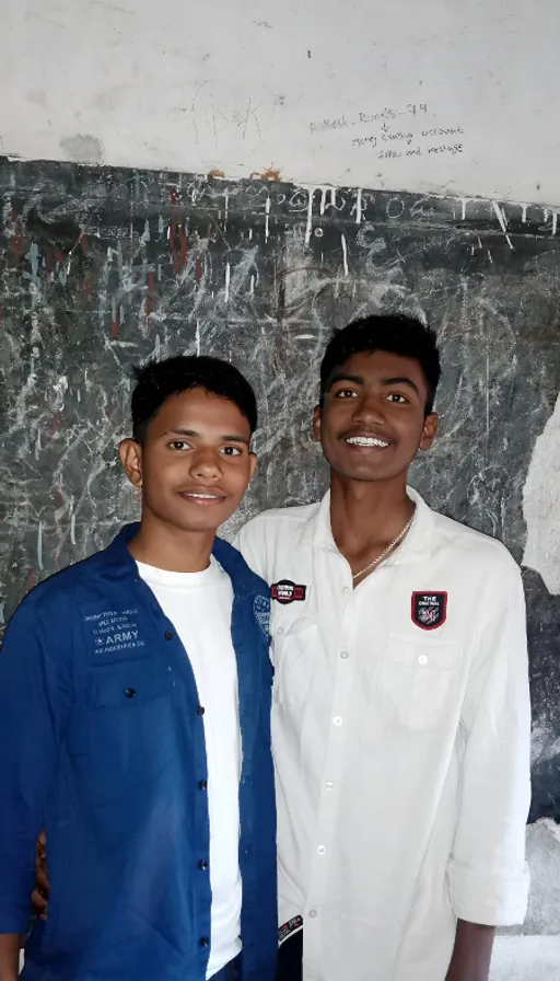 two men standing next to each other in front of a chalkboard