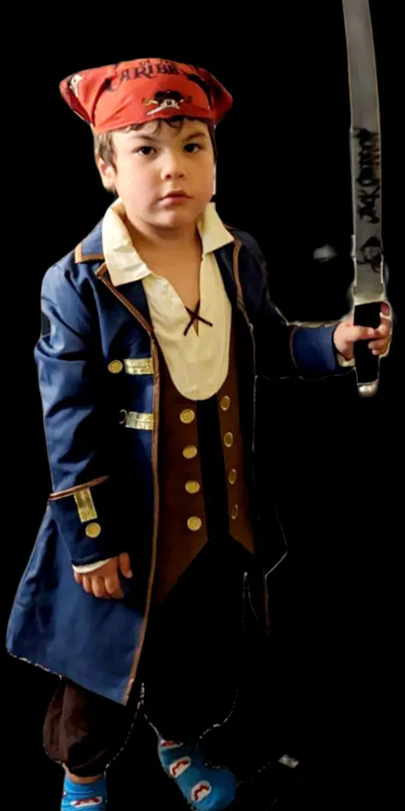 a young boy dressed in a pirate costume holding a sword