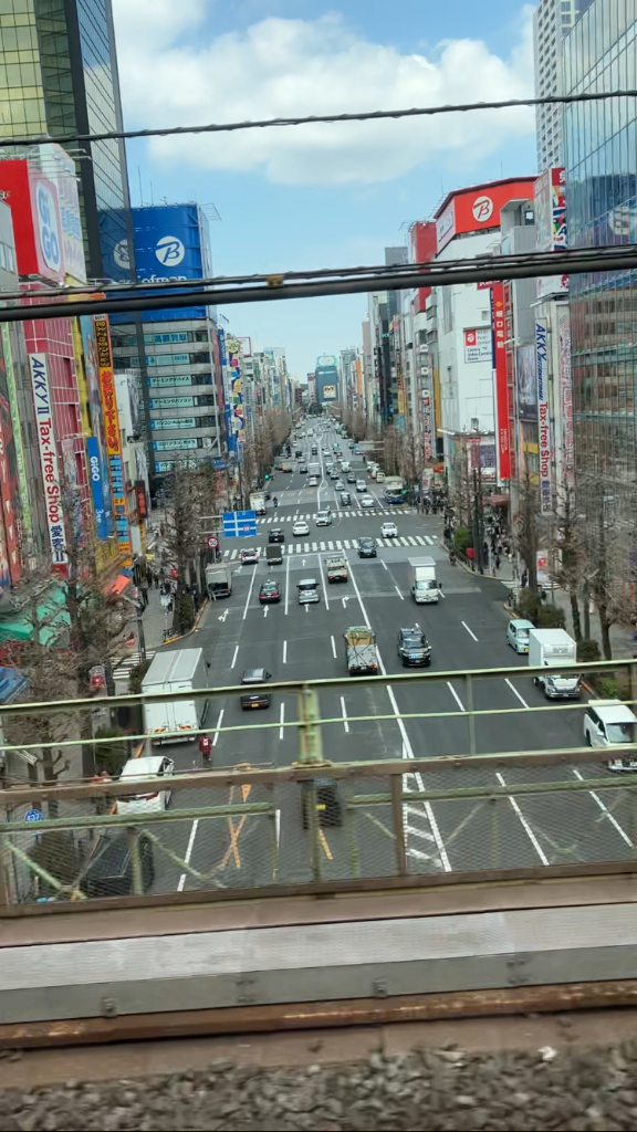 a view of a city street from a train window