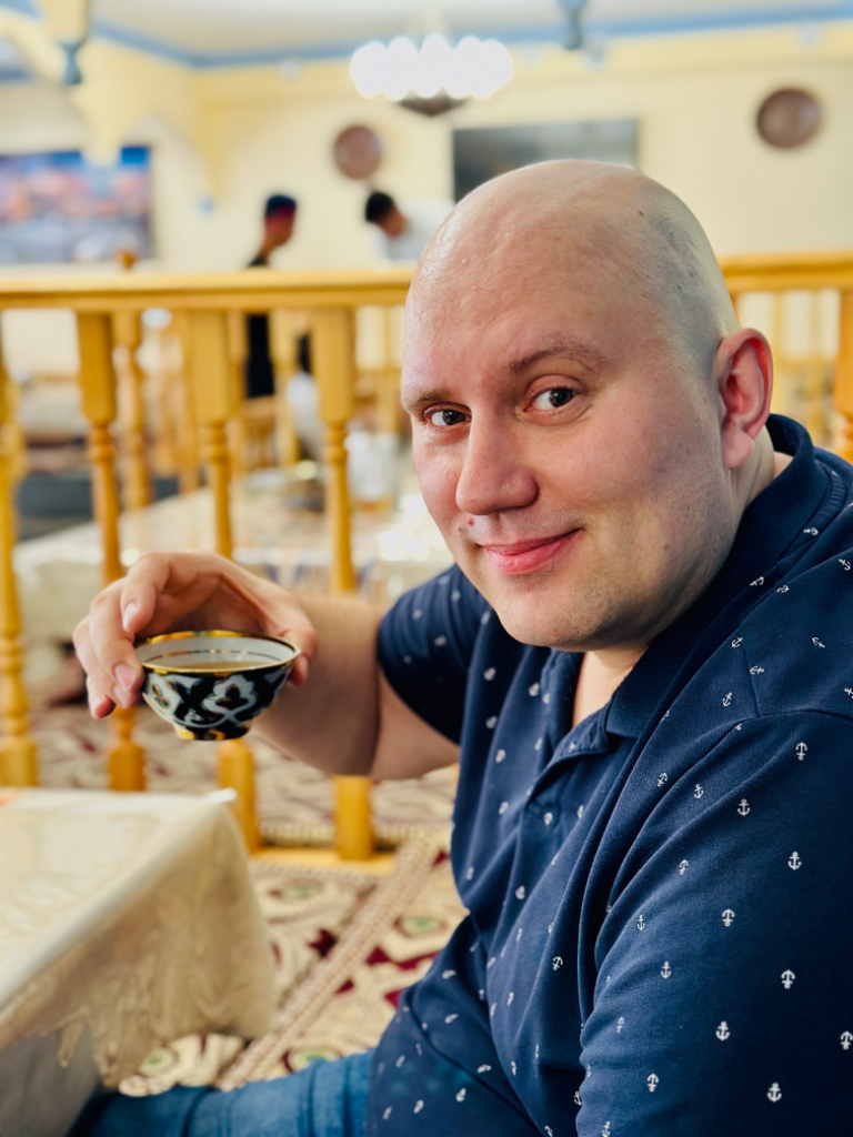 a man sitting at a table with a spoon in his hand