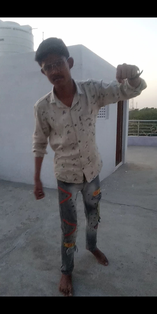 a young man standing on top of a cement floor