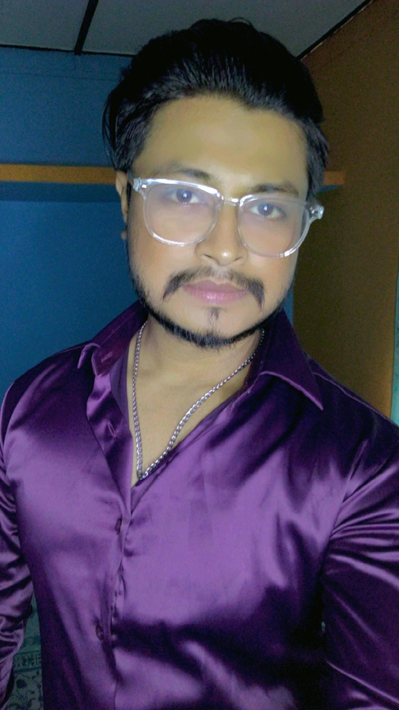 a man wearing glasses and a purple shirt