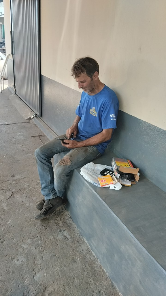 A man sitting on a bench looking at a book - Stock Photo. turn the cell phone into a book