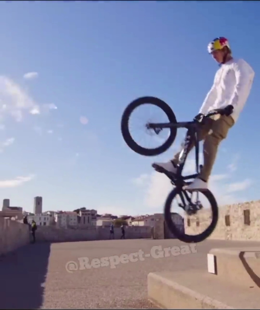 a man doing a trick on a bike in the air