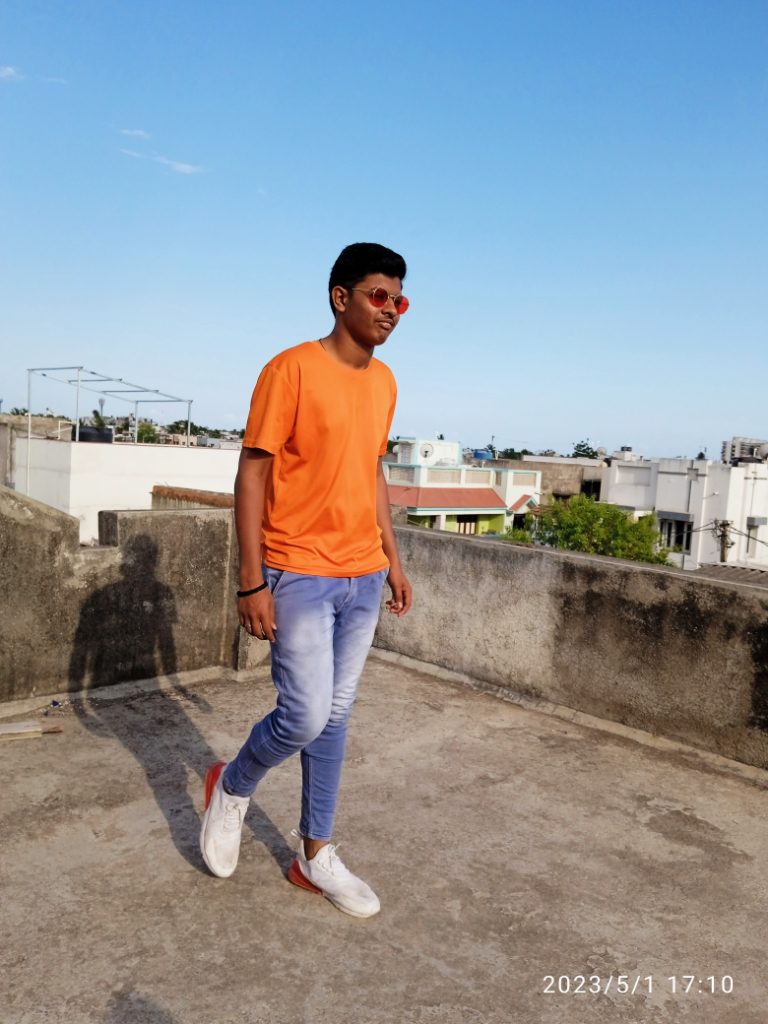 a man in an orange shirt is walking in a black and white landscape. make it a black and white landscape