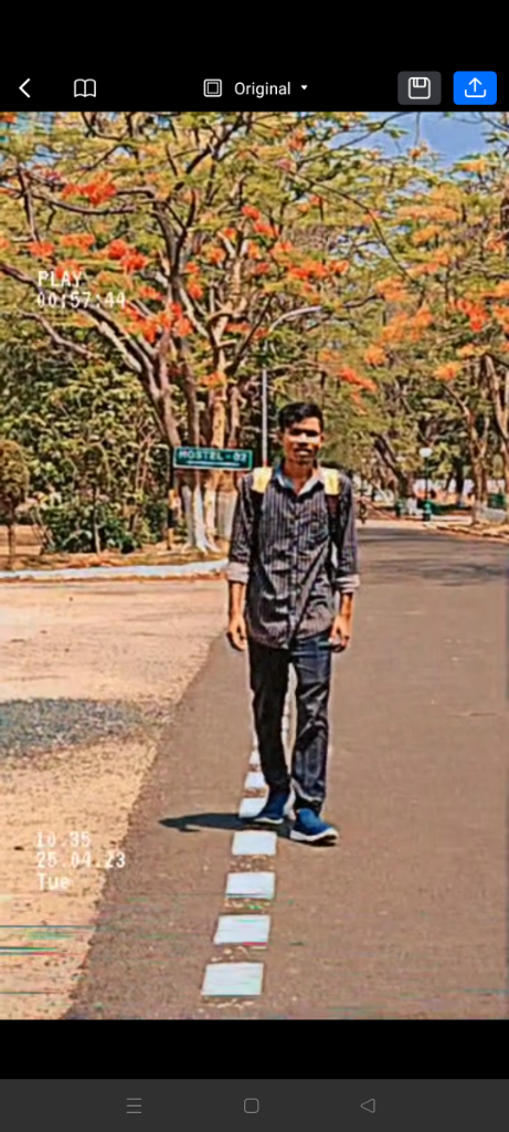 a man walking down a street next to a street sign