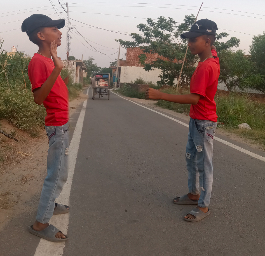 two young boys standing on the side of a road one boy is Ernest Hemingway, the other is Jack Kerouac.