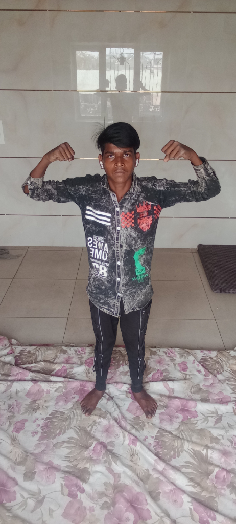 a young boy standing on top of a bed