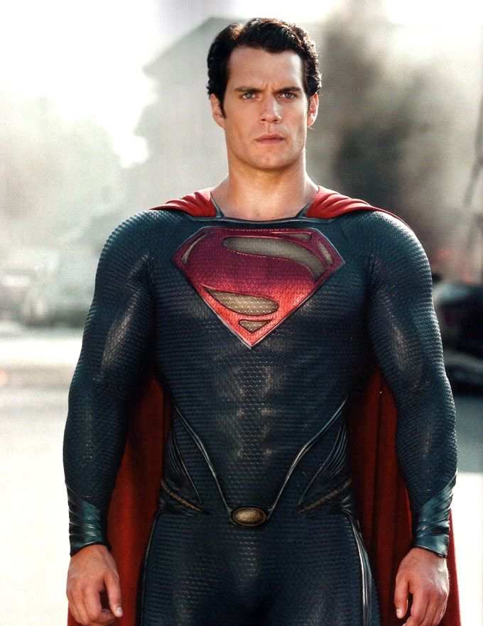 a man in a superman suit standing on a street