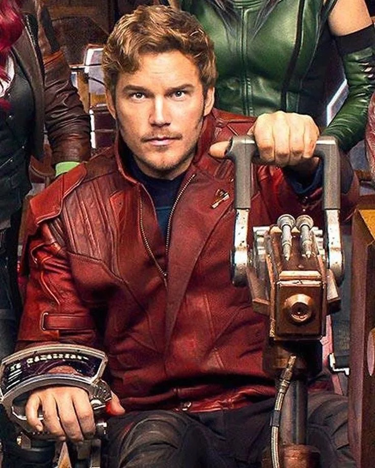 a man in a red leather jacket sitting in a chair