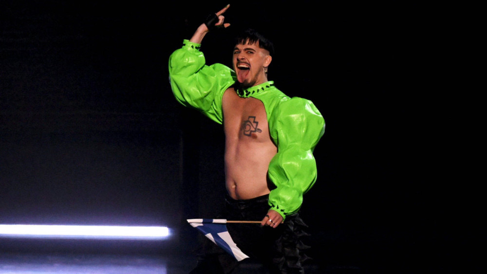 a shirtless male performing on a stage